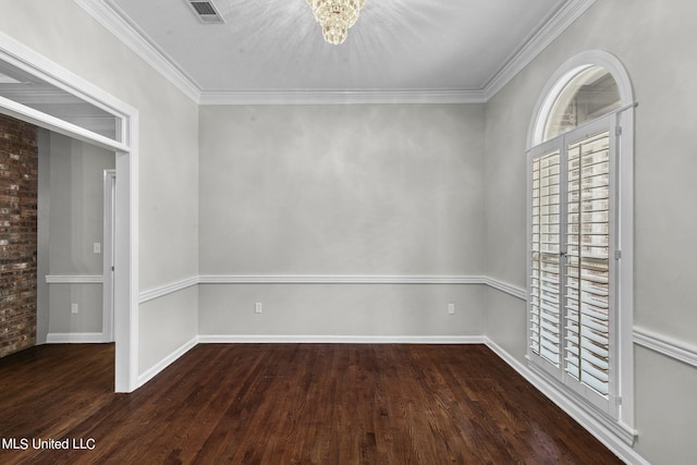 unfurnished room featuring ornamental molding, a chandelier, and dark hardwood / wood-style flooring