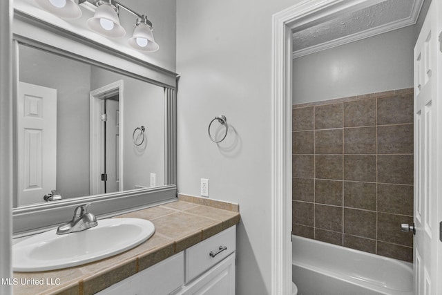 bathroom featuring vanity, ornamental molding, and bathing tub / shower combination