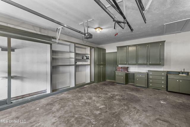 garage with a garage door opener and sink