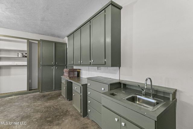 kitchen featuring gray cabinets, sink, decorative backsplash, and a textured ceiling