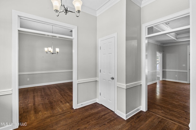 corridor with crown molding, a chandelier, coffered ceiling, and dark hardwood / wood-style flooring