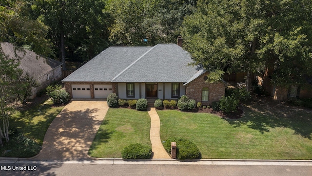 view of front of house featuring a front yard and a garage