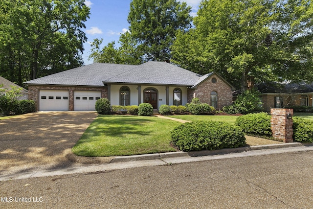 ranch-style home featuring a garage and a front lawn