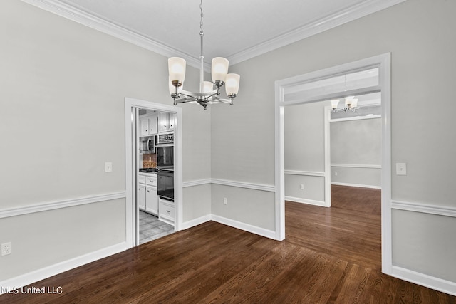 unfurnished dining area featuring crown molding, hardwood / wood-style flooring, and an inviting chandelier