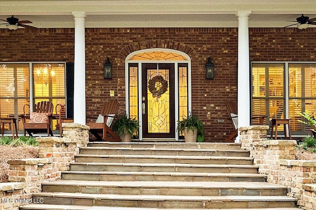 view of exterior entry featuring ceiling fan