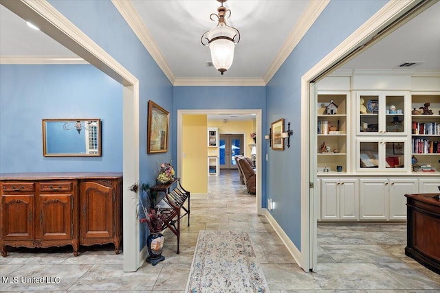 corridor with visible vents, ornamental molding, french doors, stone finish flooring, and baseboards