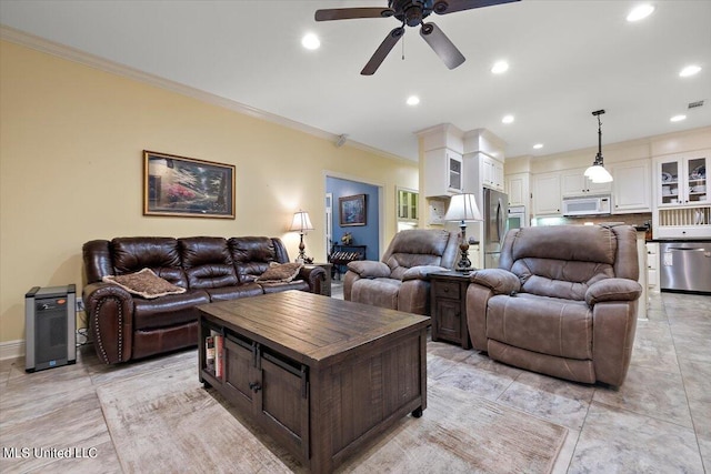 living room featuring ornamental molding and ceiling fan