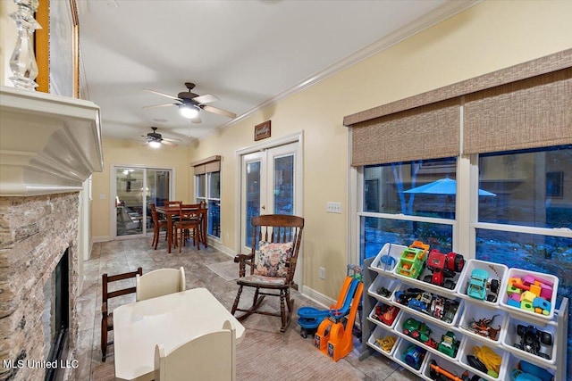 interior space featuring crown molding, a fireplace, and ceiling fan