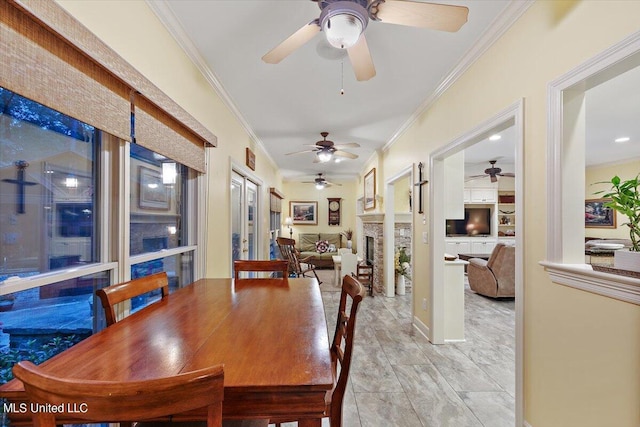 dining room featuring ornamental molding and a ceiling fan