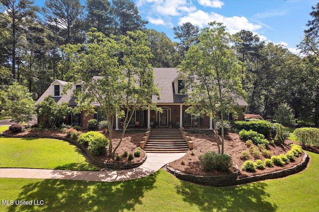 cape cod house with a front yard