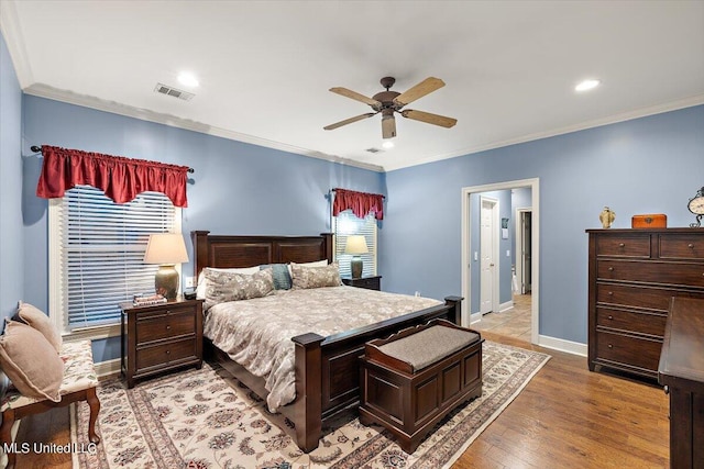 bedroom with recessed lighting, visible vents, crown molding, and baseboards
