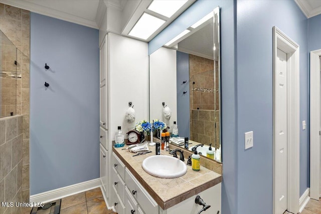 bathroom featuring vanity, ornamental molding, and tiled shower