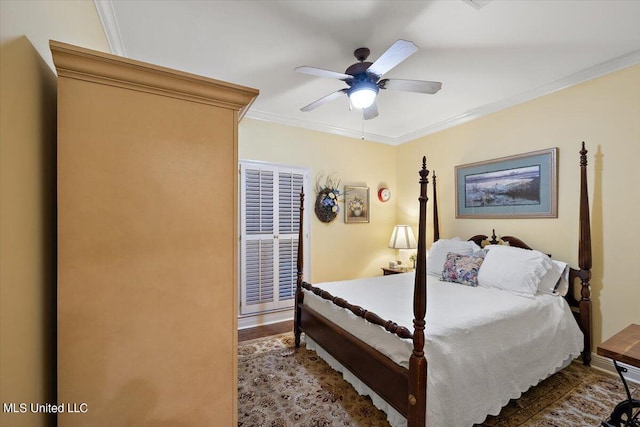 bedroom with wood finished floors, crown molding, and a ceiling fan