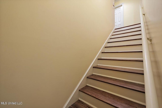 staircase featuring baseboards
