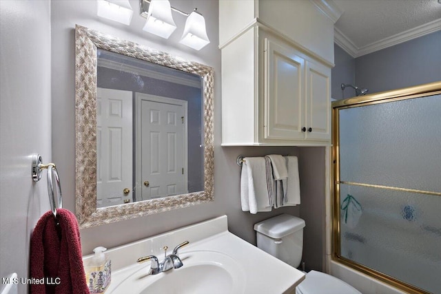 bathroom featuring enclosed tub / shower combo, toilet, ornamental molding, and vanity