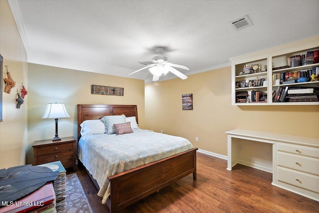 bedroom with baseboards, wood finished floors, visible vents, and a textured ceiling