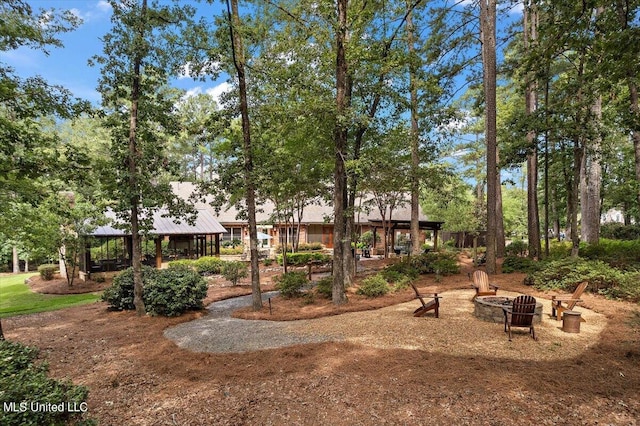 view of yard with a fire pit