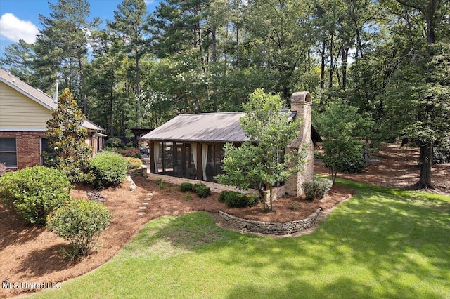 view of yard featuring a sunroom