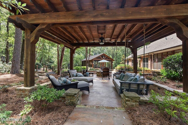 view of patio featuring an outdoor living space with a fire pit and a ceiling fan