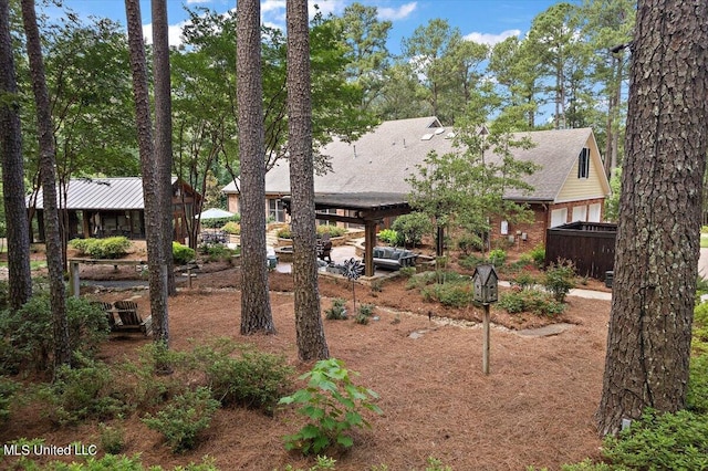 view of yard with fence and a carport