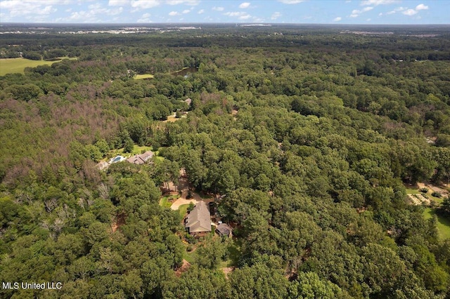 drone / aerial view with a wooded view