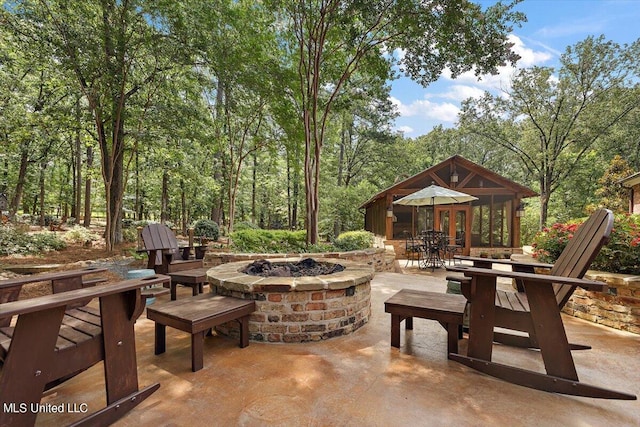 view of patio / terrace with a fire pit and outdoor dining space