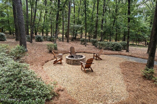 view of yard with a fire pit