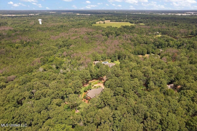 drone / aerial view featuring a forest view