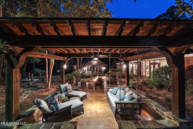 patio at twilight with ceiling fan and an outdoor hangout area