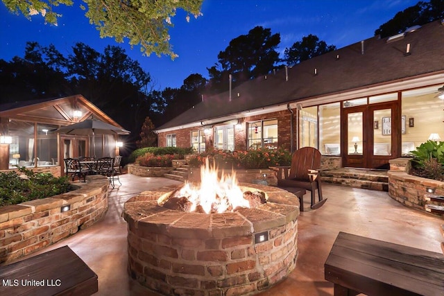 patio at night with an outdoor fire pit