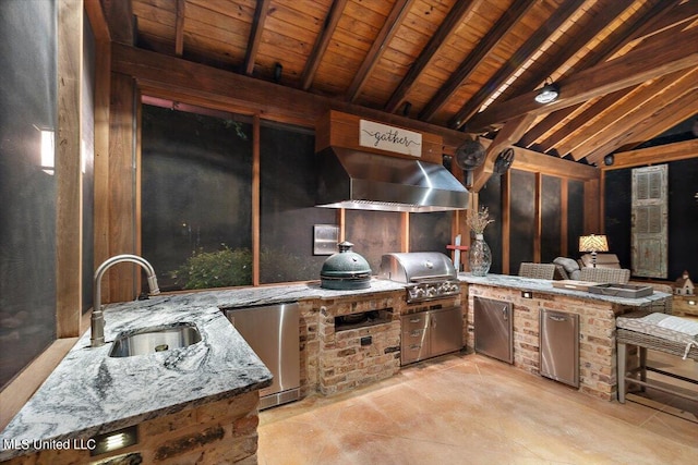 view of patio with exterior kitchen, a sink, and area for grilling