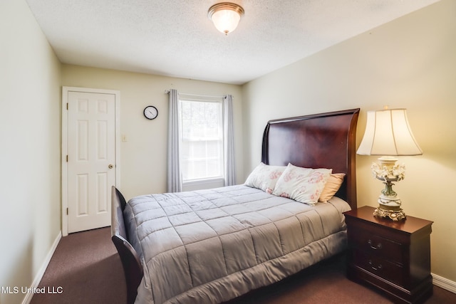 176 Briarfield Ave, Biloxi, MS 39531 - bedroom featuring dark colored carpet, baseboards, and a textured ceiling