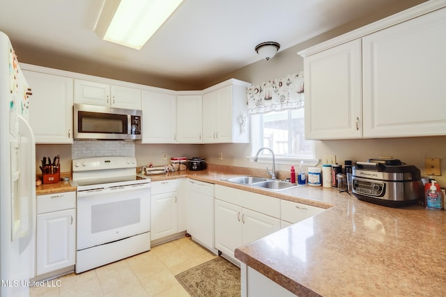 176 Briarfield Ave, Biloxi, MS 39531 - kitchen with white appliances, a sink, and white cabinetry