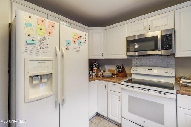 176 Briarfield Ave, Biloxi, MS 39531 - kitchen with white appliances, white cabinetry, and tasteful backsplash