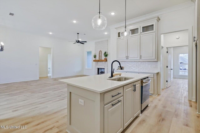 121 Ashby Ridge Dr, Canton, MS 39046 - kitchen featuring a sink, dishwasher, light countertops, a ceiling fan, and hanging light fixtures