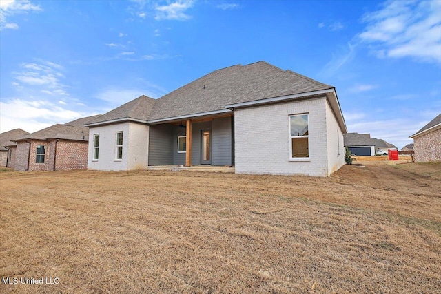 121 Ashby Ridge Dr, Canton, MS 39046 - rear view of property with brick siding, a yard, and roof with shingles