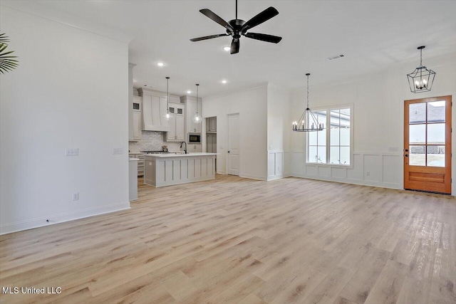 121 Ashby Ridge Dr, Canton, MS 39046 - unfurnished living room featuring a chandelier, light wood-type flooring, a sink, ceiling fan, and recessed lighting