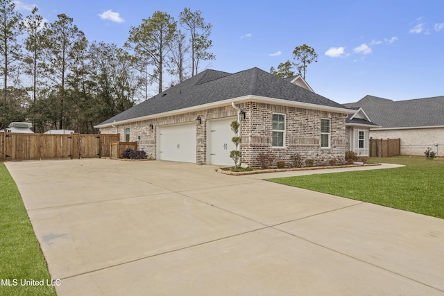 ranch-style house with a garage and a front lawn