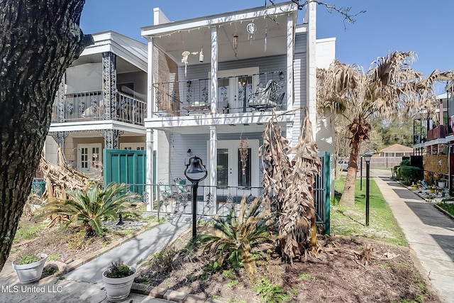 view of front of home with covered porch and a balcony