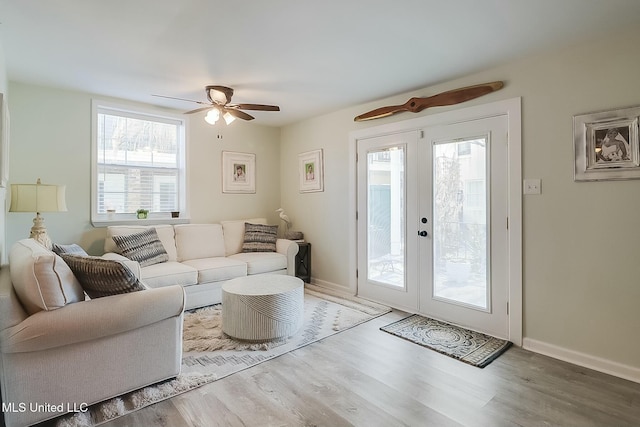 living room with ceiling fan, french doors, wood finished floors, and baseboards