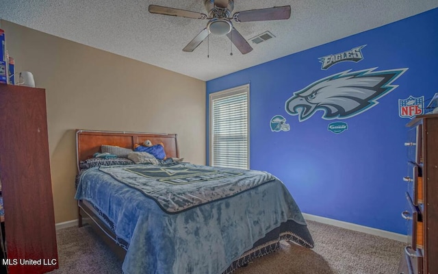 carpeted bedroom with a textured ceiling and ceiling fan