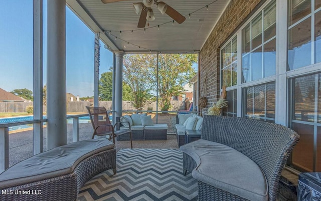 sunroom featuring ceiling fan