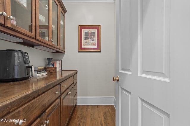 bar with dark hardwood / wood-style flooring