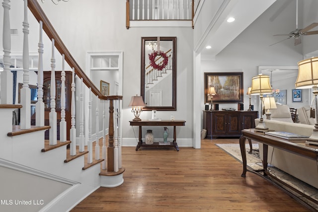 entrance foyer with a high ceiling, hardwood / wood-style floors, and ceiling fan