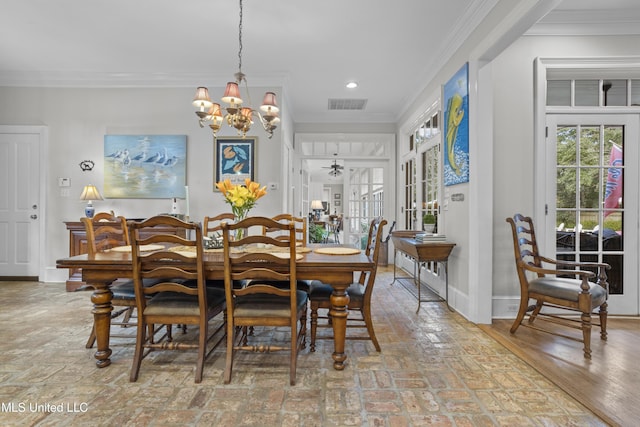 dining room with crown molding and a notable chandelier