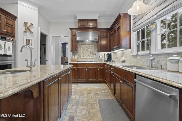 kitchen featuring tasteful backsplash, sink, wall chimney exhaust hood, and appliances with stainless steel finishes