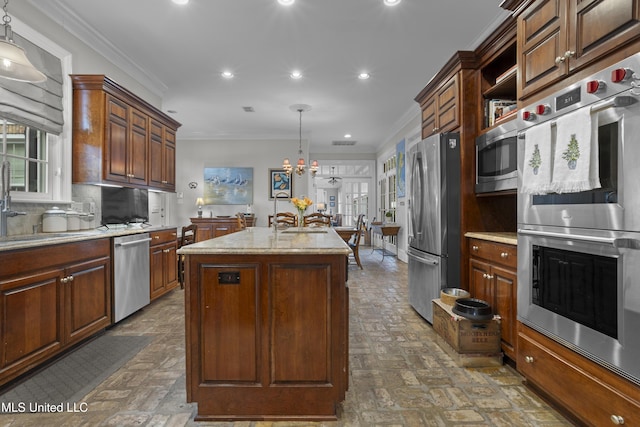 kitchen featuring crown molding, a center island with sink, pendant lighting, stainless steel appliances, and decorative backsplash