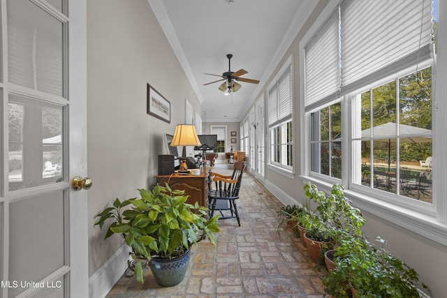 sunroom featuring ceiling fan