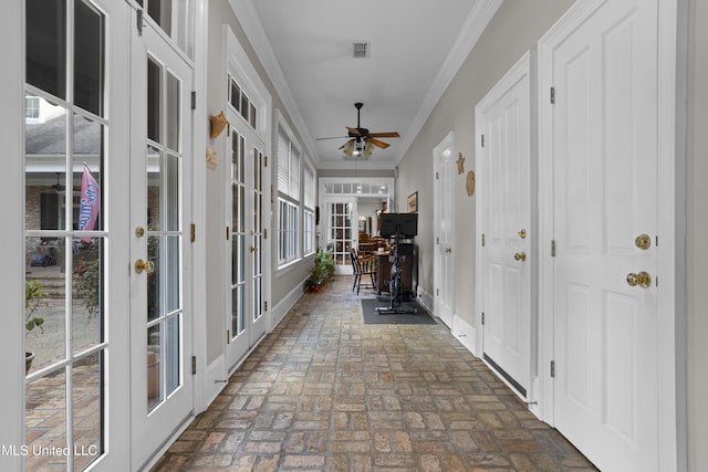 hall with ornamental molding and french doors