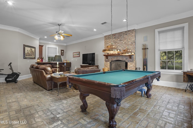 playroom with crown molding, a brick fireplace, pool table, and ceiling fan